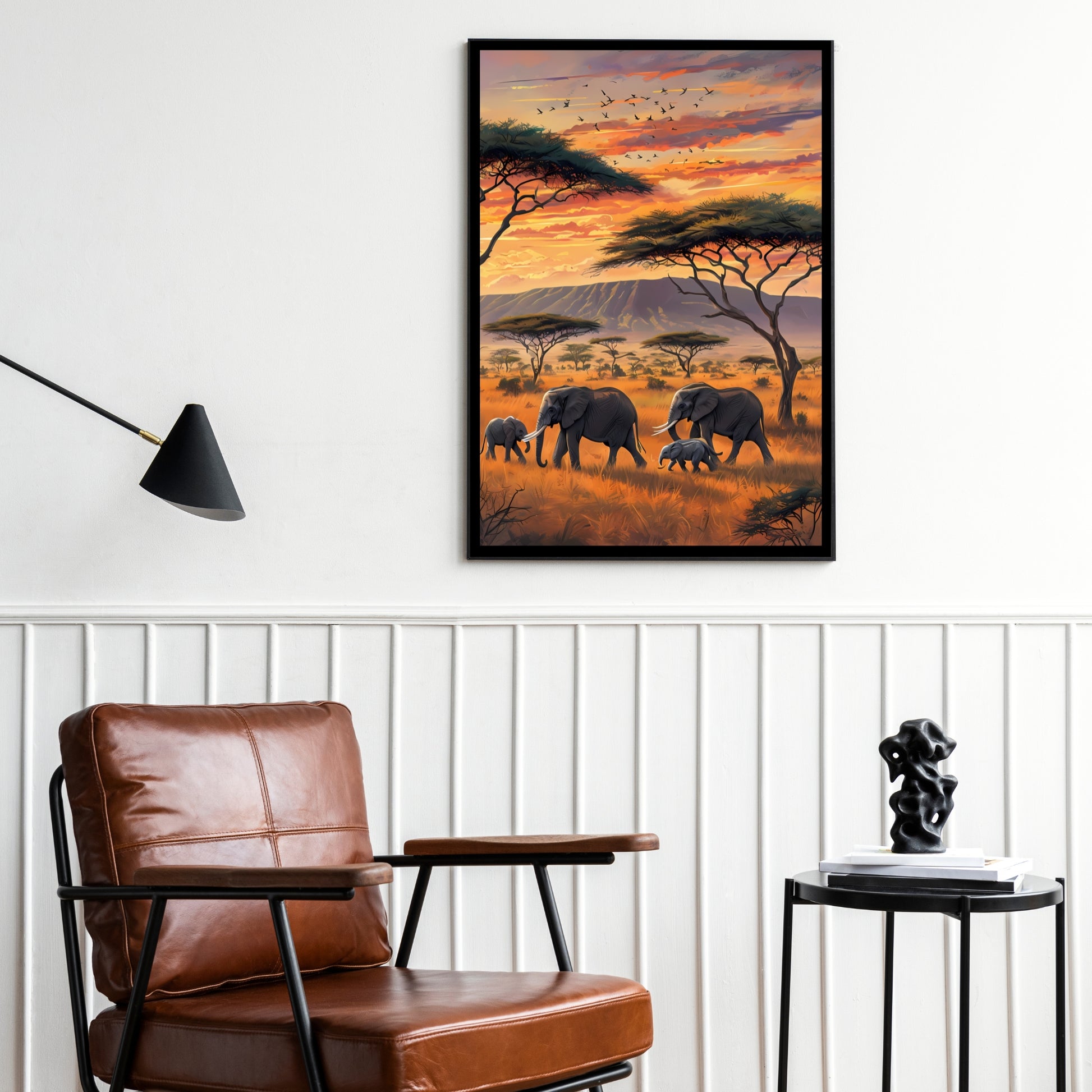 A stunning high-quality print of a group of elephants in Tanzania with acacia trees and a mountain range in the background.

