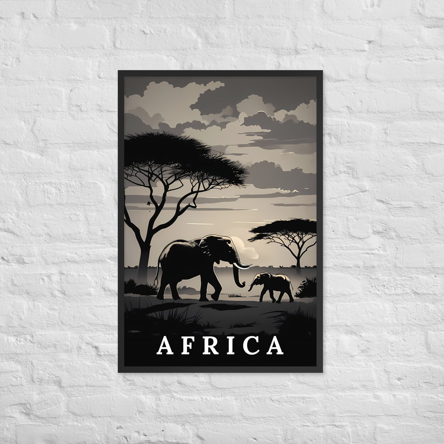 A framed travel poster of Africa featuring silhouettes of elephants, acacia trees, and a cloudy sky, displayed on a white brick wall.