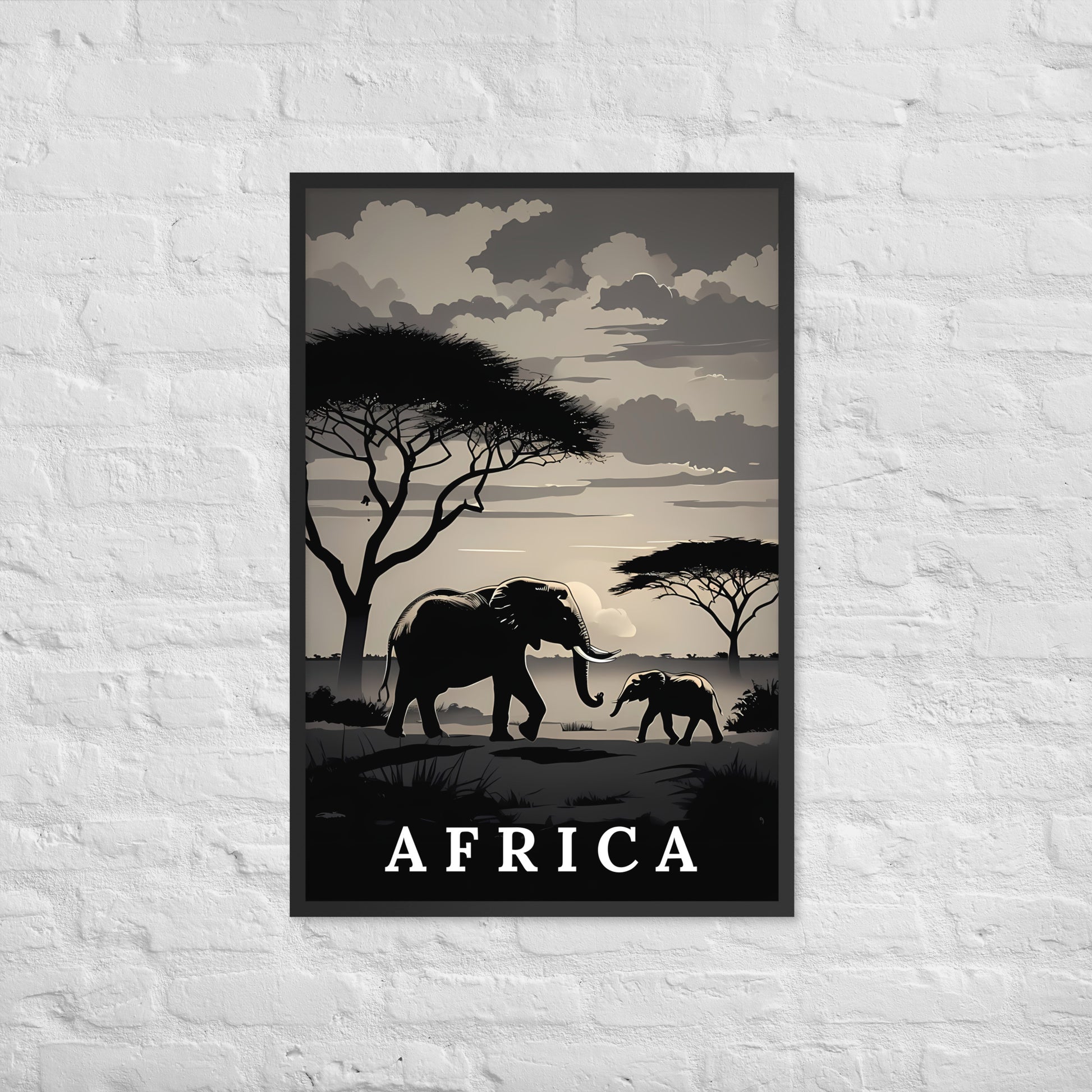 A framed travel poster of Africa featuring silhouettes of elephants, acacia trees, and a cloudy sky, displayed on a white brick wall.