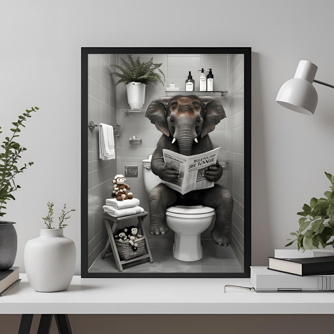Framed artwork of an elephant reading a newspaper on a toilet in a bathroom setting.